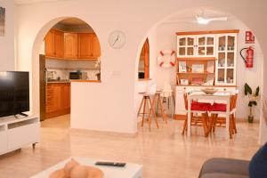 a living room and kitchen with a table and chairs at Villa Preciosa de Luxe and Spa in Mazarrón