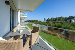 a patio with a table and chairs on a balcony at Strandresort Prora - Wohnung 213 in Binz