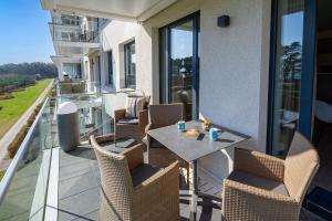a patio with a table and chairs on a balcony at Strandresort Prora - Wohnung 213 in Binz