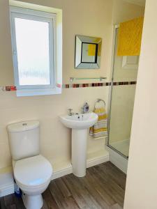 a bathroom with a toilet and a sink at The Coach House in Par +33 photos