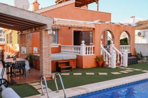a backyard with a swimming pool and a house at Villa Preciosa de Luxe and Spa in Mazarrón