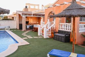 a house with a swimming pool and a house with a yard at Villa Preciosa de Luxe and Spa in Mazarrón
