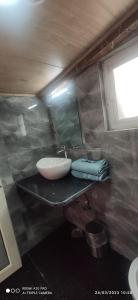 a bathroom with a sink and a mirror at New Malook hotel in Shimla