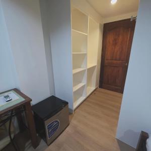 a room with a closet with a desk and a door at Sunflower Residences Capitol in Cebu City