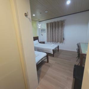 a hospital room with two beds and a window at Sunflower Residences Capitol in Cebu City