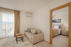 a living room with a couch and a bed and a mirror at Adriatic Sea Escape B20 in Herceg-Novi +28 photos