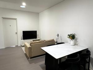 a living room with a couch and a tv at June Stay in Perth