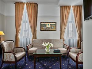 a living room with a couch and chairs and a table at Hotel President in Bielsko-Biała
