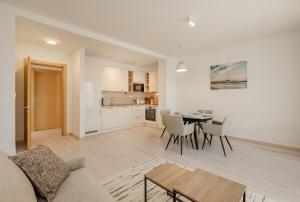 a living room and kitchen with a couch and a table at Adriatic Sea Escape B20 in Herceg-Novi