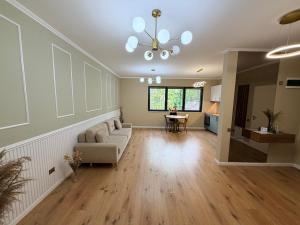 a living room with a couch and a table at Ophir Apartment Ultracentral,the greenest and brightest central area,3 parking space in the large yard in Cluj-Napoca