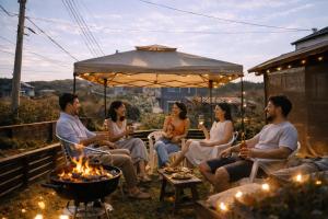 a group of people sitting around a fire pit at Aloha Beach Deck , Oceanfront, Stunning Sunrises, BBQ, Karaoke in Hokota