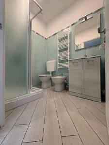 a bathroom with two toilets and a glass shower at b&b La Rosa dei venti in Alassio +51 photos