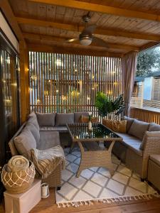 a screened in porch with a couch and a table at Mobile Home Sea Heaven in Biograd na Moru
