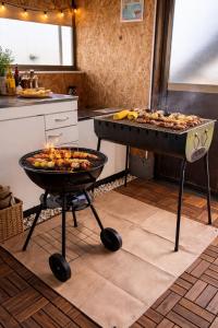 a bbq and a grill in a kitchen with food at Aloha Beach Deck , Oceanfront, Stunning Sunrises, BBQ, Karaoke in Hokota +69 photos