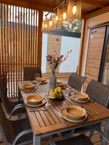 a wooden table with a vase of fruit on it at Mobile Home Sea Heaven in Biograd na Moru