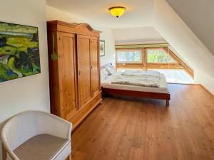 a bedroom with a bed and a wooden cabinet at Landhaus Rubitz in Rubitz +13 photos
