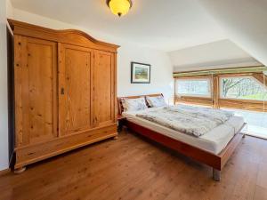 a bedroom with a large wooden cabinet and a bed at Landhaus Rubitz in Rubitz
