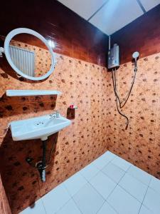 a bathroom with a sink and a mirror at Patong Adventure Hostel in Patong Beach +69 photos