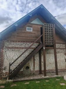 a brick building with a staircase in front of it at Le refuge du chat endormi in Goderville