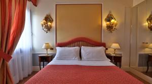 Postel nebo postele na pokoji v ubytování Hotel Arlecchino