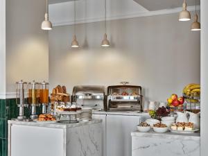 a kitchen with a counter with food on it at Hotel President in Bielsko-Biała