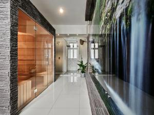 a bathroom with a glass shower in a building at Hotel President in Bielsko-Biała