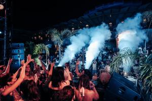 a crowd of people raising their hands at a concert at Lost Seaside Hotel - Adults Only in Sarandë +170 photos