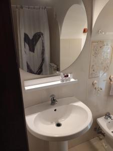a white bathroom with a sink and a mirror at Borgo Vallelunga house Campagnano Di Roma in Campagnano di Roma +17 photos