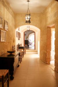 a hallway with a dining room with a table and chairs at Historic Villa with a Private Pool in Mosta