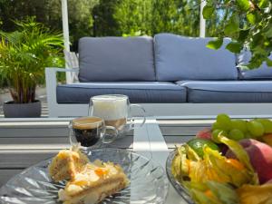 a table with a plate of food and a glass of wine at NOVA ULINIA Forest - dom nad morzem, podgrzewany basen , sauna, balia z jacuzzi, Starlink in Ulinia