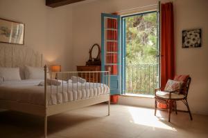 a bedroom with a bed and a window and a chair at Historic Villa with a Private Pool in Mosta +86 photos