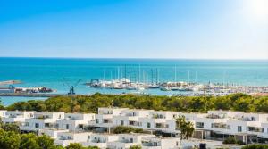 a view of a harbor with white buildings and boats at Villa Kala in Sant Pere de Ribes
