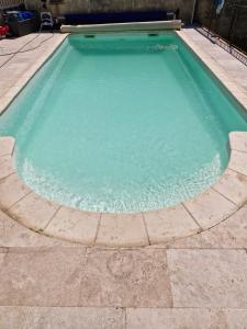 a swimming pool with a turquoise water at Chez faby José in Avignon