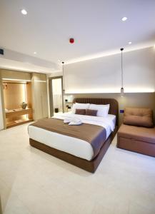 a large bedroom with a large bed and a couch at Licorne Suites in Tirana