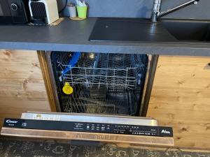 a dishwasher with a laptop on top of it at Il Mulino - Bilocale in centro in Ponte di Legno