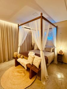 a bedroom with a canopy bed and a rug at Pousada Varanda Amar - Icaraizinho de Amontada in Icaraí +271 photos