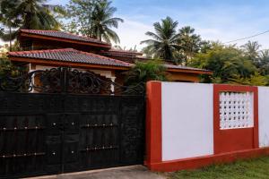 a black gate in front of a house at Aqua Dream Adventures Resort in Trincomalee