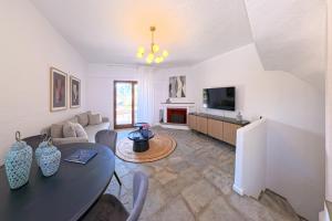 a living room with a couch and a table at Elani Blue Coast Maisonette in Elani