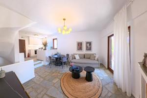 a living room with a couch and a table at Elani Blue Coast Maisonette in Elani