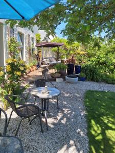 a patio with a table and chairs in a yard at Redmoor in Saint Day