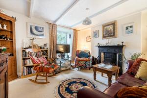 a living room with a couch and a fireplace at Redmoor in Saint Day
