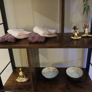 a shelf with towels towels and a doll on it at Celessentielle à 10 min de Pairi Daiza , gîte romantique in Jurbise