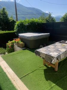 a large bath tub sitting on top of green grass at lake view chalet Doussard Annecy in Doussard