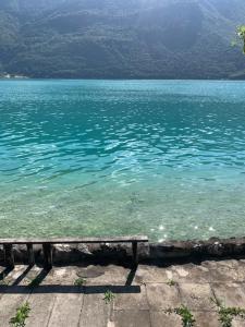 a large body of water with a bench in it at lake view chalet Doussard Annecy in Doussard