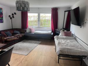 a living room with a couch and a window at Landhaus Falkennest in Flintsbach am Inn