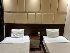 two beds sitting next to each other in a room at Grand Elite Hotel in Cairo +7 photos