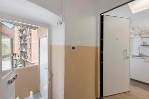 a hallway with a door and a window at The Hemme's Home in Genoa