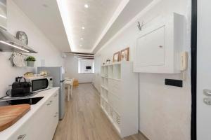 a kitchen with white cabinets and a refrigerator at The Hemme's Home in Genoa +25 photos