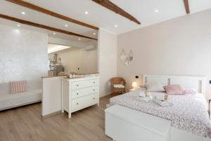 a bedroom with a white bed and a white dresser at The Hemme's Home in Genoa