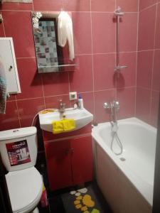 a bathroom with a sink and a toilet and a bath tub at Квартира in Sumy